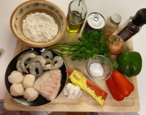 make a Moqueca ( brazilian seafood stew) bell peppers, fish, scallops, shrimp ,olive oil, herbs, tomato paste, onions, garlic' and coconut milk and flour to fry seafood.