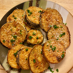 A plate with baked eggplants.