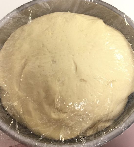 Proofed Bread dough in a bowl  for sweet coconut bread recipe 