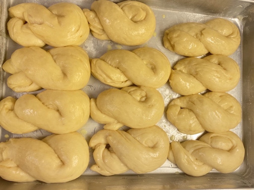 A baking tray with sweet coconut bread proofing