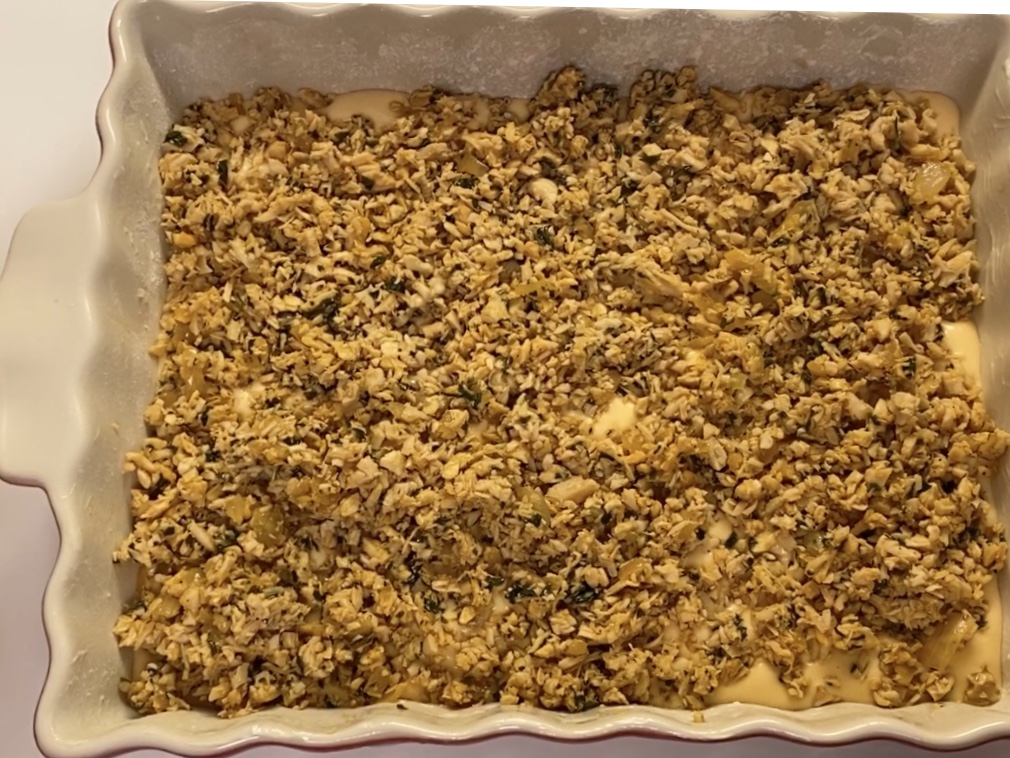 A baking dish with shredded chicken filling 