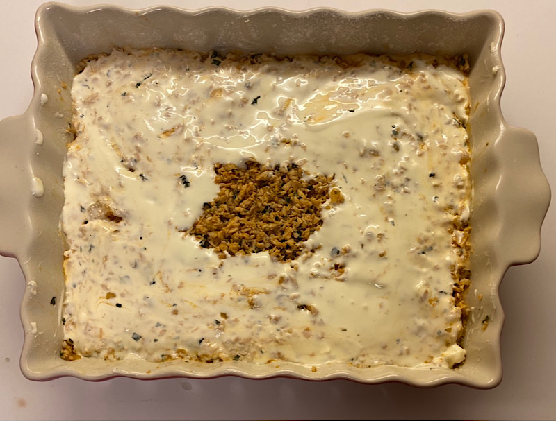 A baking dish with soufflé batter with brazilian catupiry cream cheese 