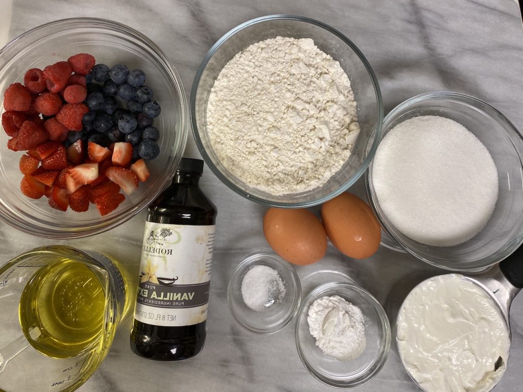 Simple- and-easy-triple-berry-Muffins-ingredients- flour-baking -powder-berries-salt- vanilla, eggs, oil-sugar-and-greek yogurt to bake Fluffy Triple-Berry muffins recipe ingredients
