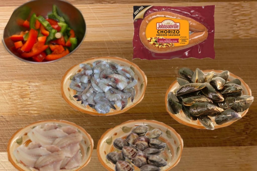 Ingredients clams, mussels, fish and chorizo to make the best seafood paella recipe